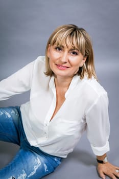 adult attractive woman in middle age portrait against gauem background