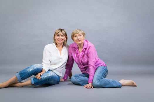 older adult happy wife mother with adult daughter portrait generation against grey background