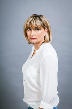 adult attractive woman in middle age portrait against gauem background