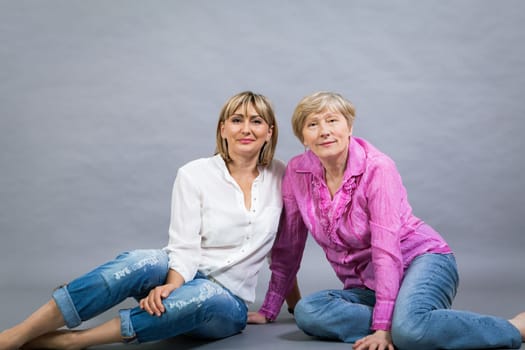 older adult happy wife mother with adult daughter portrait generation against grey background