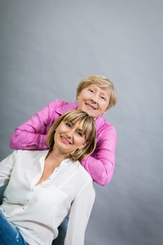 older adult happy wife mother with adult daughter portrait generation against grey background