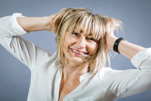 adult attractive woman in middle age portrait against gauem background
