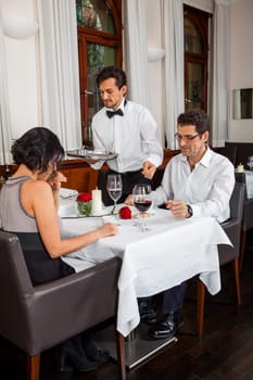 Young couple group in a restaurant cheerful while drinking