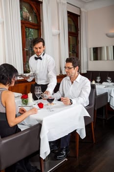 Young couple group in a restaurant cheerful while drinking