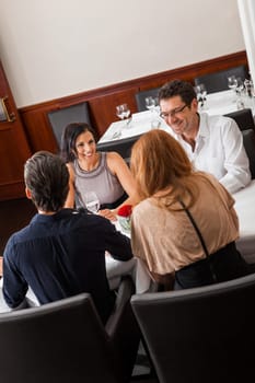 Young couple group in a restaurant cheerful while drinking
