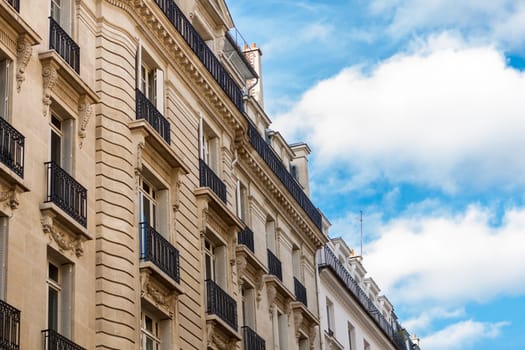Exterior view of a Parisian townhouse in summer in front of a blue sky