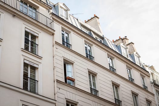 Exterior view of a Parisian townhouse in summer in front of a blue sky