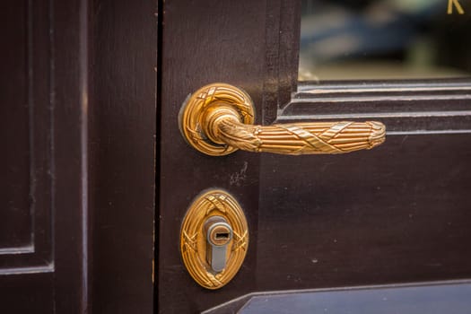 Doorknob doorknob on a wooden door entrance at a house as a close-up