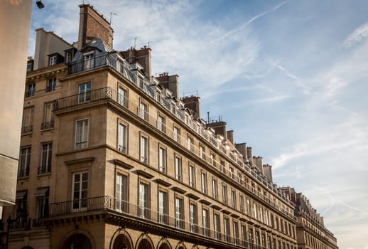 Exterior view of a Parisian townhouse in summer in front of a blue sky