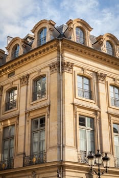 Exterior view of a Parisian townhouse in summer in front of a blue sky
