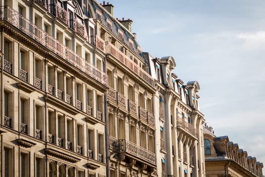 Exterior view of a Parisian townhouse in summer in front of a blue sky