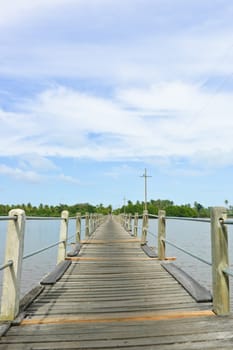 Long wood bridge over a river in low angle view