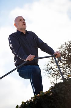 Man middle-aged senior pensioner taking a break in the outdoor park