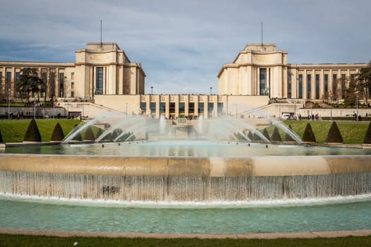 Park in Paris near the Eiffel Tower with a fountain on a sunny day