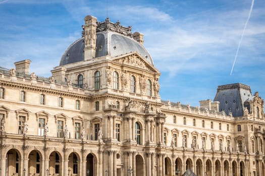 Exterior view of a Parisian townhouse in summer in front of a blue sky