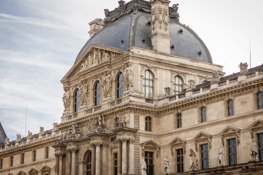 Exterior view of a Parisian townhouse in summer in front of a blue sky