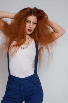 Young attractive pretty woman with long red hair and ripped hairstyle in portrait