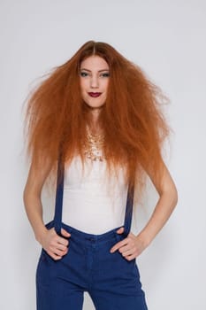 Young attractive pretty woman with long red hair and ripped hairstyle in portrait