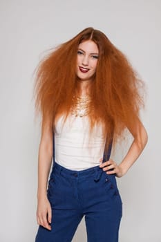 Young attractive pretty woman with long red hair and ripped hairstyle in portrait