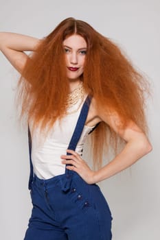 Young attractive pretty woman with long red hair and ripped hairstyle in portrait