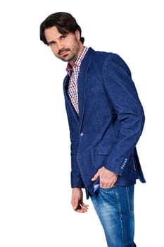 Young man in trendy casual look with dark hair and beard isolated against a white background