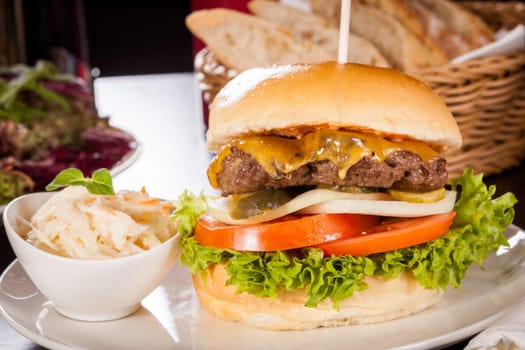 Delicious hamburger cheeseburger with bacon egg and salad on a plate
