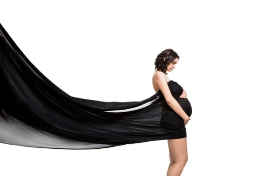 Young attractive pregnant woman wrapped in black fabric insulated against white background