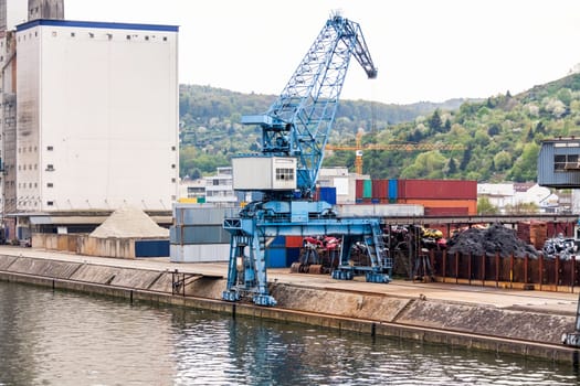 Dock in the port with stacked containers at the dock for import and export cargo with blue sky