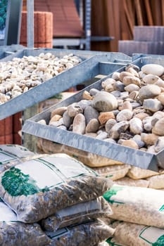 presentation of different types of gravel and sand in a display in gate construction