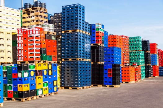 Stacked beverage crates with deposit bottles in an open-air beverage market