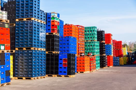 Several stacks of colorful beverage bottle crates outdoors