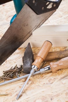 DO-it-yourself tool with cordless screwdriver,screwdriver,saw and screws in a workshop