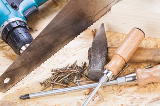 DO-it-yourself tool with cordless screwdriver,screwdriver,saw and screws in a workshop