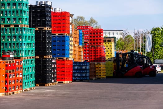 Several stacks of colorful beverage bottle crates outdoors
