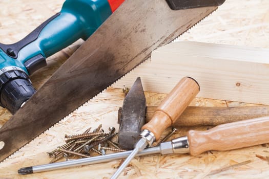 DO-it-yourself tool with cordless screwdriver,screwdriver,saw and screws in a workshop