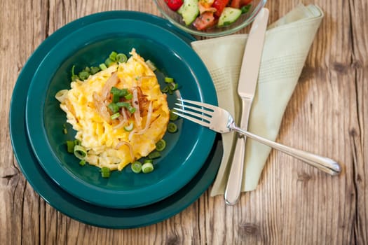 Plate of fresh cheese maccaroni or cheese chips in close-up on a wooden table