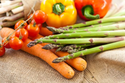 Fresh vegetables with tomatoes,peppers and asparagus as a close-up on an outdoor table