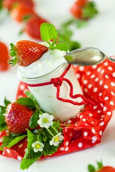 Fresh yoghurt with strawberries in a glass insulated on a white background