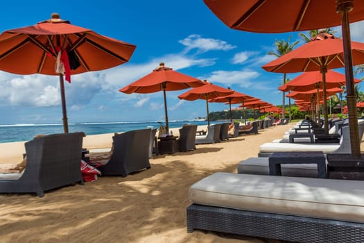Tropical beach with sun lounger and umbrellas with white sand in the Caribbean