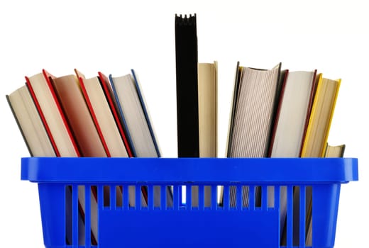 Plastic shopping basket with books isolated on white