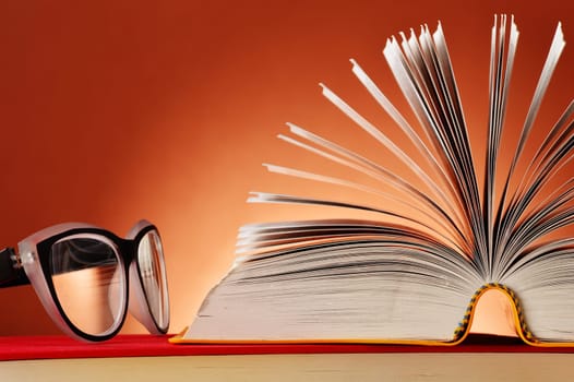 Composition with glasses and books on the table