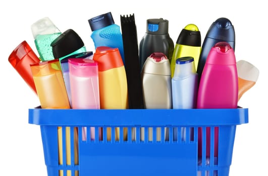 Plastic shopping basket with plastic bottles of body care and beauty products