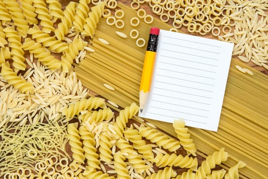 Uncooked pasta and blank paper for recipe