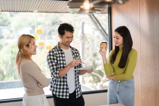 A group of diverse professionals engages in a collaborative discussion, sharing ideas and insights in a contemporary office setting.