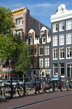 Bicycles on the bridge in Amsterdam. (Netherlands). Vertically. All potential trademarks are removed.