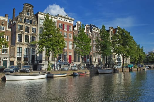 The houses along the canals in Amsterdam. (The Netherlands). All potential trademarks are removed.