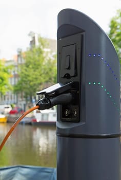 Detailed view of the electric car charger with connected cable.