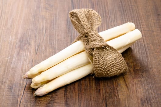 Bunch white asparagus on a brown table