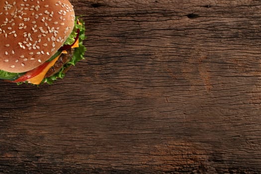 Tasty hamburger on wood background. Space for text