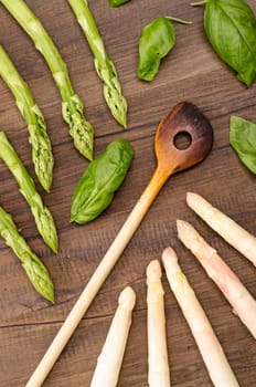 Cooking spoon and white and green asparagus